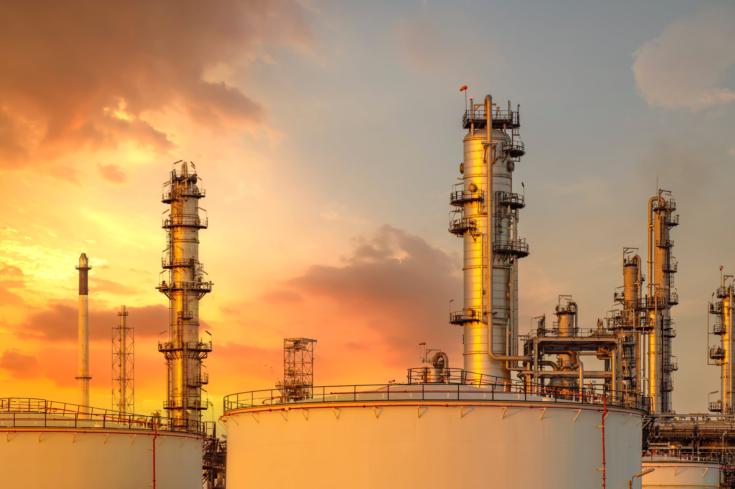 majestic petrochemical oil refinery plant glows under power full sky as industrial chimneys and towers release steam